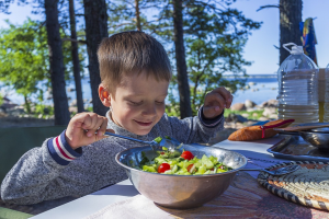 child eating a salad